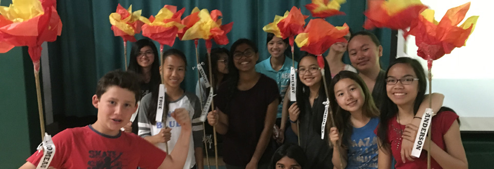 St. Patrick Catholic School Grade 8 class holding tissue paper flowers.