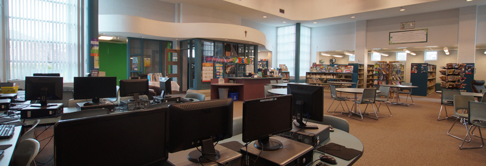 Computers, tables and books in a school library
